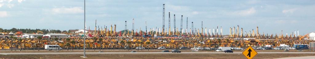 excess used construction equipment at a roadside storage lot in Florida