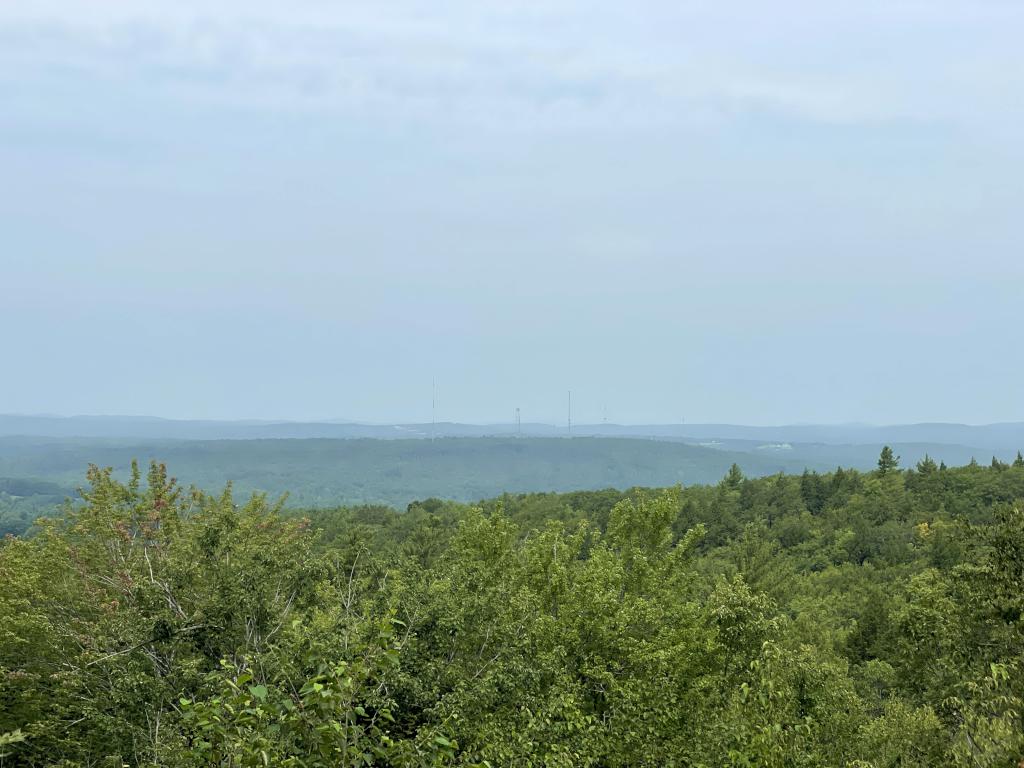 view in August from Bauneg Beg Mountain Middle Peak obscured by forest fire smoke in southwest Maine