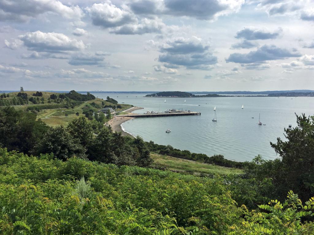 view toward the Spectacle Island dock from the island's northern peak at Boston Harbor in Massachusetts