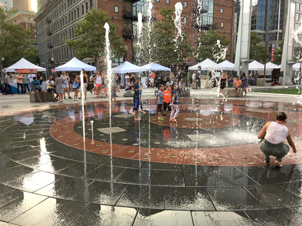 kids enjoy a play fountain near Long Wharf at Boston Harbor in Massachusetts