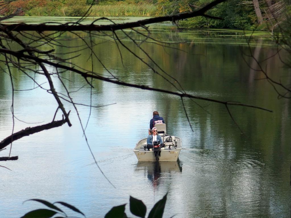 fishing couple in September on the Nashua River beside Flints Brook Trail near Hollis in southern New Hampshire