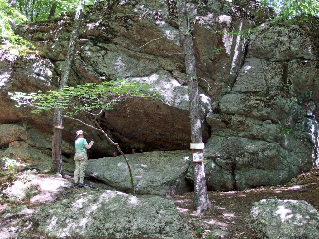 Andee checks out Winnie the Pooh's cave home on the Pooh Trail at Goodwill Conservation Area in southeastern New Hampshire