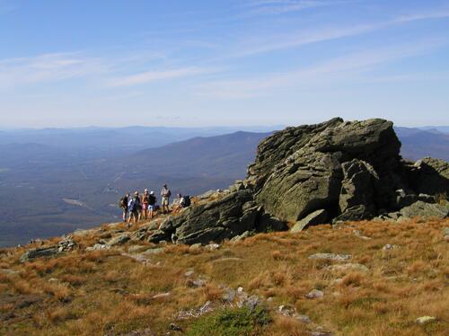 hikers gather near one of the castle rock formations on the descent via the Castle Trail from Mount Jefferson in the White Mountains of New Hampshire