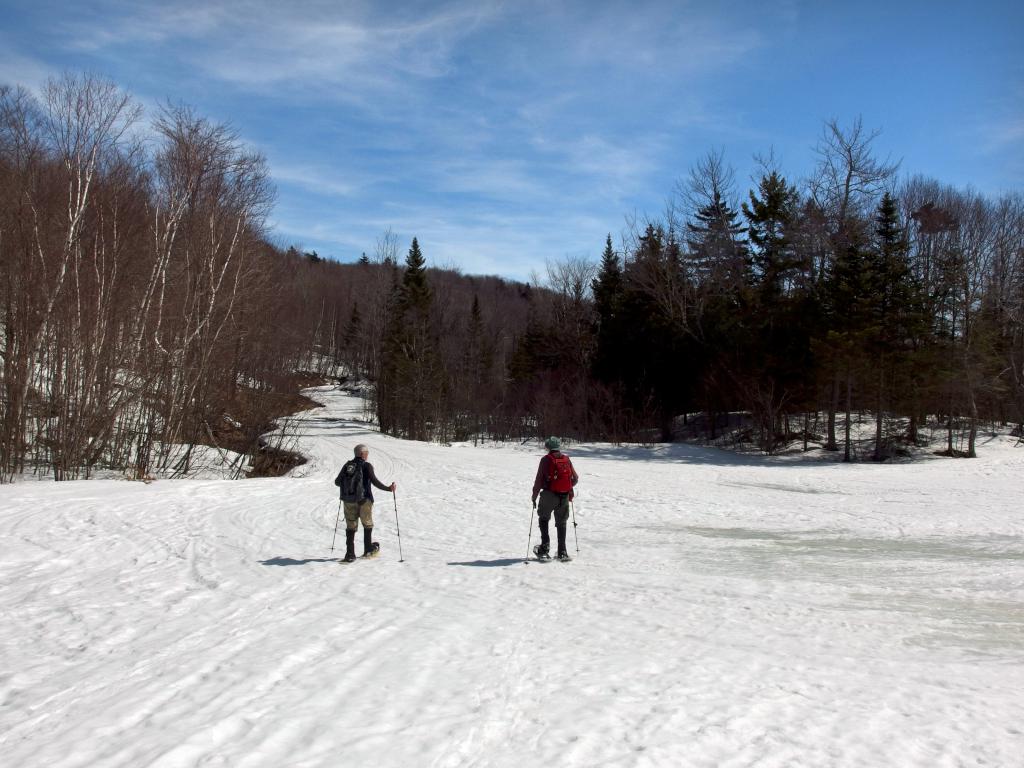 Dick and John hike Bryant Pond Road in April on the way back from Kimball Hill in New Hampshire