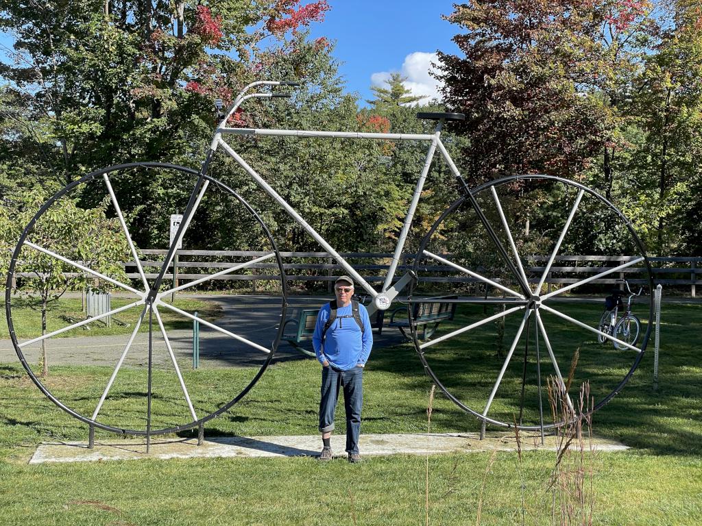 Len and trailside modern art in October on the North Central Pathway near Winchendon in northern Massachusetts