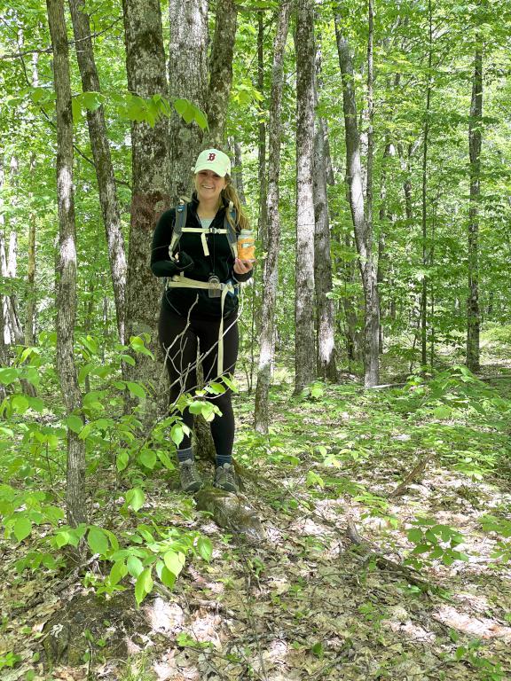 Elise with the hiker canister in May atop Ore Hill in New Hampshire