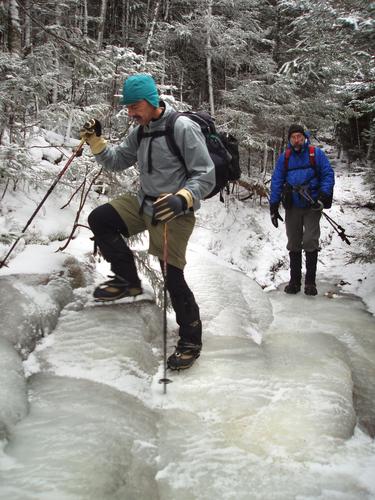 hikers on an icy trail to Mount Osceola in New Hampshire
