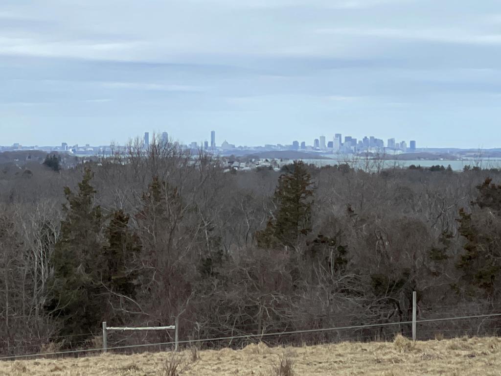 view of Boston skyline in March as seen from Turkey Hill in eastern Massachusetts