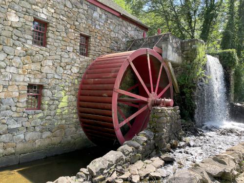 Grist Mill water wheel in June at Wayside Inn Historic Site in eastern MA