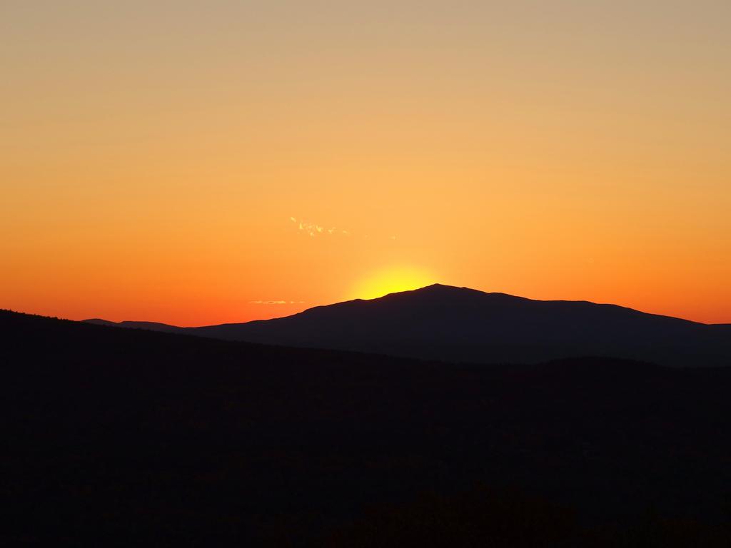 fiery sunset behind Mount Monadnock as seen from Winn Mountain in southern New Hampshire