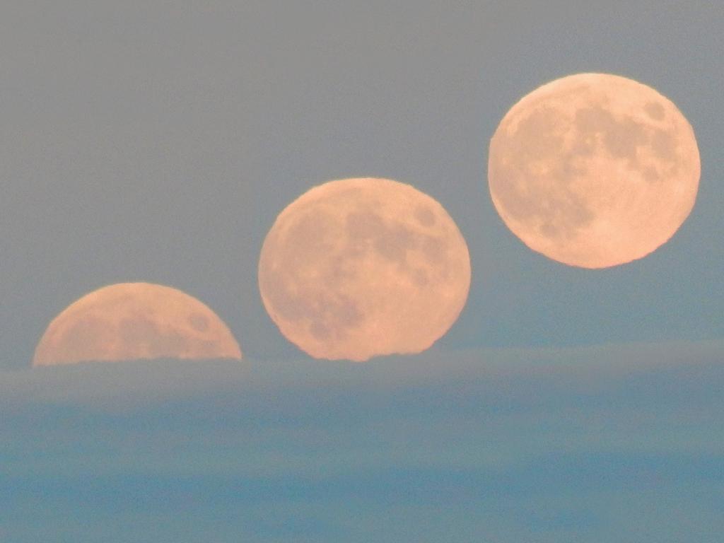 progressive moonrise (collage photo) as it rises at sunset above a low cloud layer, as seen from Winn Mountain in New Hampshire