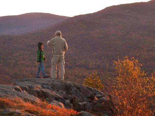 hikers atop Winn Mountain at sunset in New Hampshire