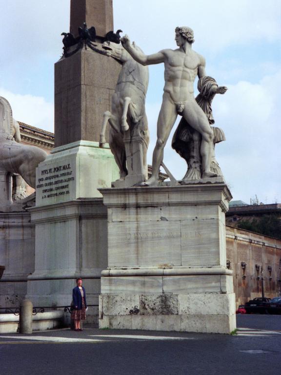 Betty Lou stands beside a huge statue in Rome, Italy