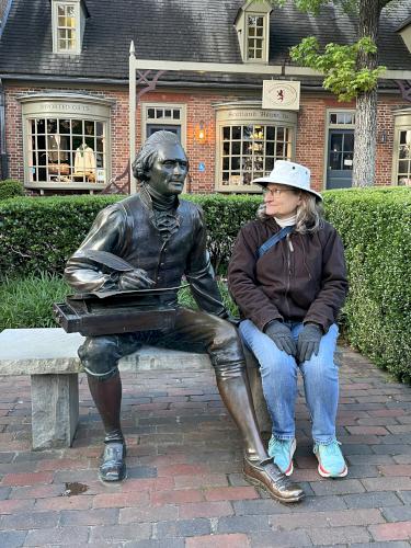 Andee with a statue in May at Colonial Williamsburg in Virginia