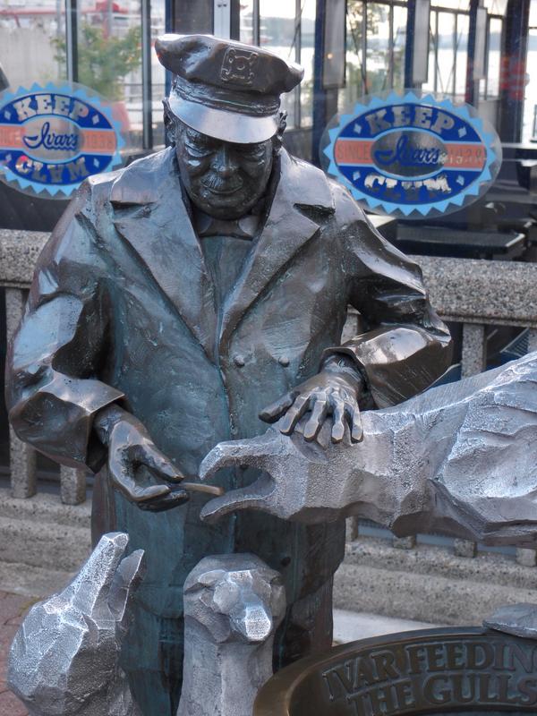 statue outside Ivars restaurant of the founder feeding seagulls at Seattle in Washington