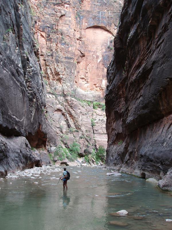 hiker canyoneering up The Narrows at Zion National Park in Utah